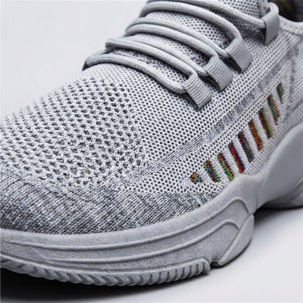 Close-up of men's lightweight trainers, highlighting the breathable mesh upper for comfort.