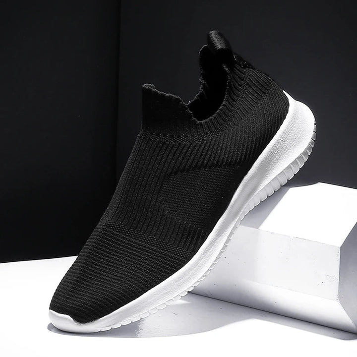 Black men's slip-on sneakers, designed for ultimate comfort & everyday wear. Lightweight athletic walking shoes.