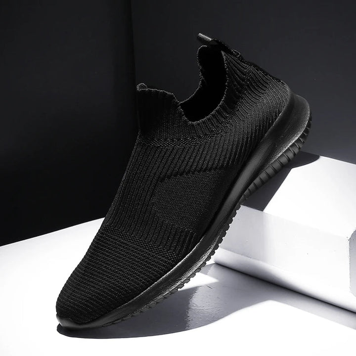 Stylish white men's slip-on runners. Comfortable & lightweight casual sneakers, ideal for walking & daily activities.