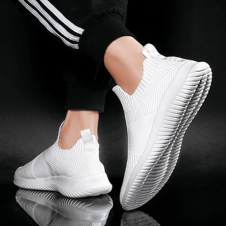 Men's white everyday slip-on sneakers. Lightweight & comfortable athletic shoes for walking, running errands & casual wear.