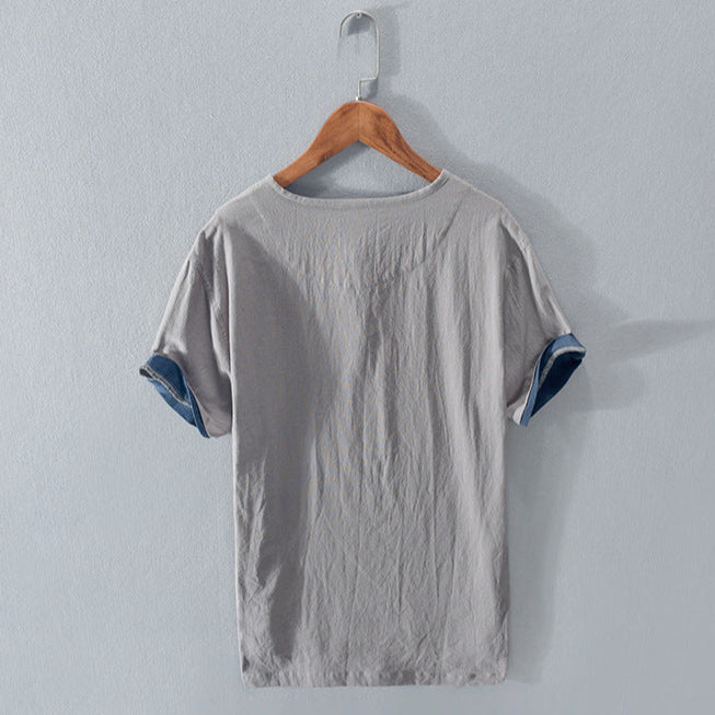 Close-up of a men's Henley shirt placket. Smart-casual buttonless top detail for men's effortless style.
