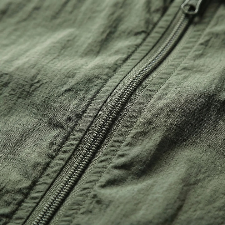Men's lightweight hooded tactical windbreaker jacket. Water-repellent activewear for outdoor hiking & sports.