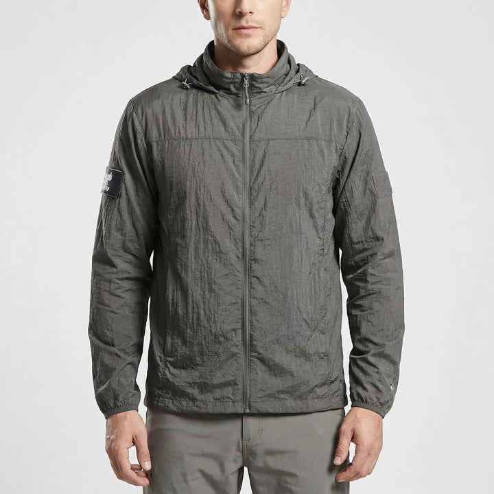 Versatile men's hooded tactical windbreaker. Lightweight, water-repellent jacket for hiking & outdoor activewear.