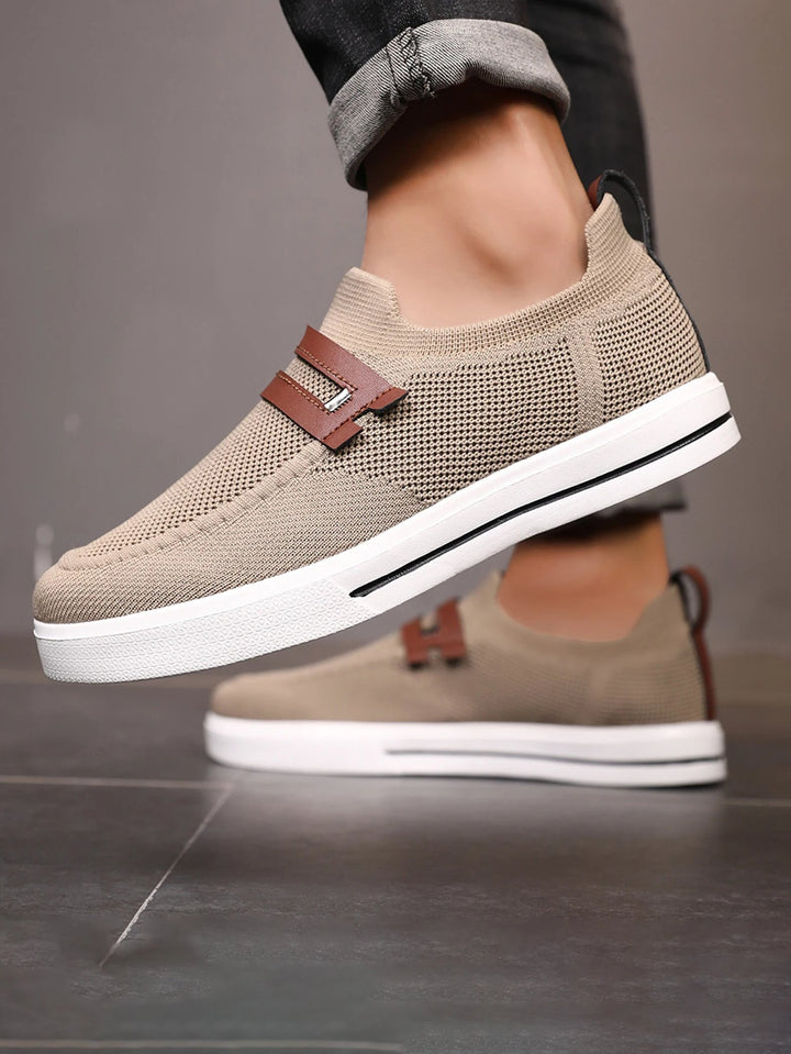 Close-up of men's breathable mesh slip-on loafers, showcasing lightweight design & comfort features.