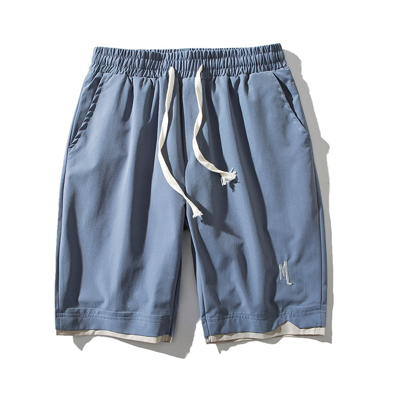 Close-up of the fabric texture of men's lightweight performance shorts with pocket detail.