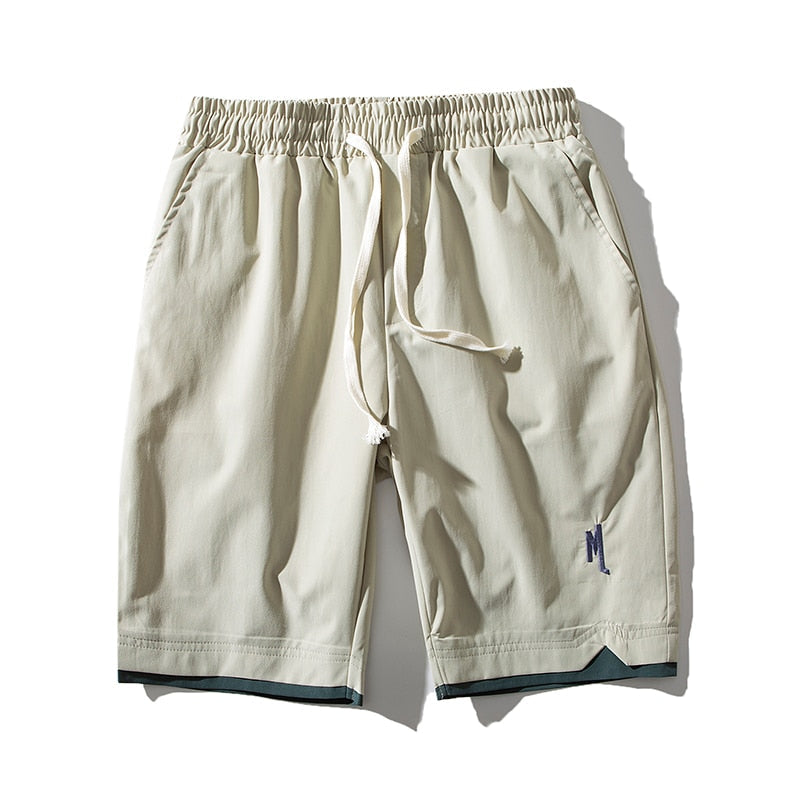 Man wearing blue Dante lightweight performance shorts, showcasing their casual summer style and fit.