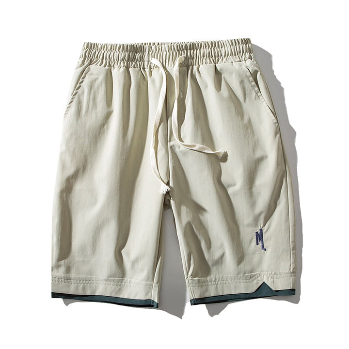 Man wearing blue Dante lightweight performance shorts, showcasing their casual summer style and fit.
