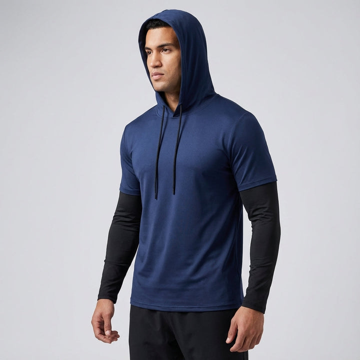 Man wearing a gray men's performance training hoodie during an outdoor run, showcasing athletic fit and style.