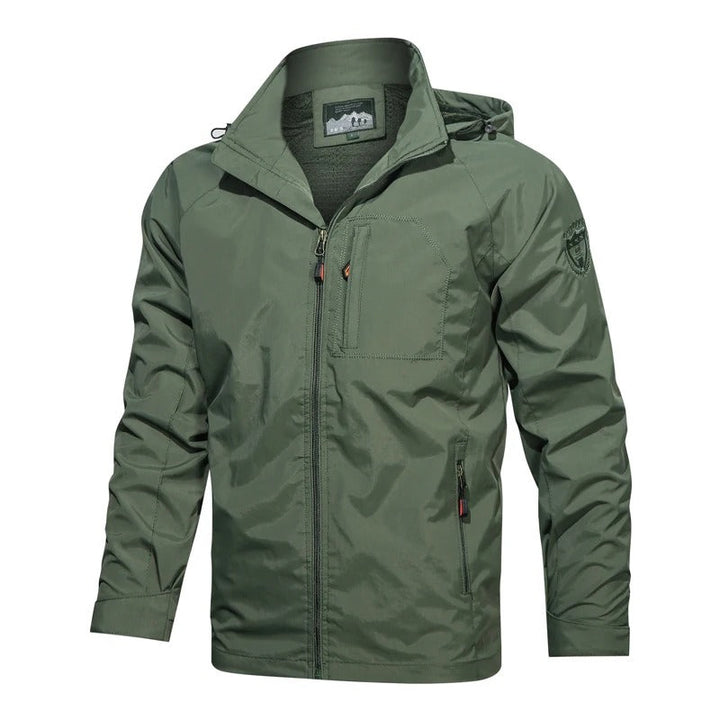 Man wearing a versatile lightweight summer jacket while hiking. Durable & comfortable men's outdoor adventure gear.