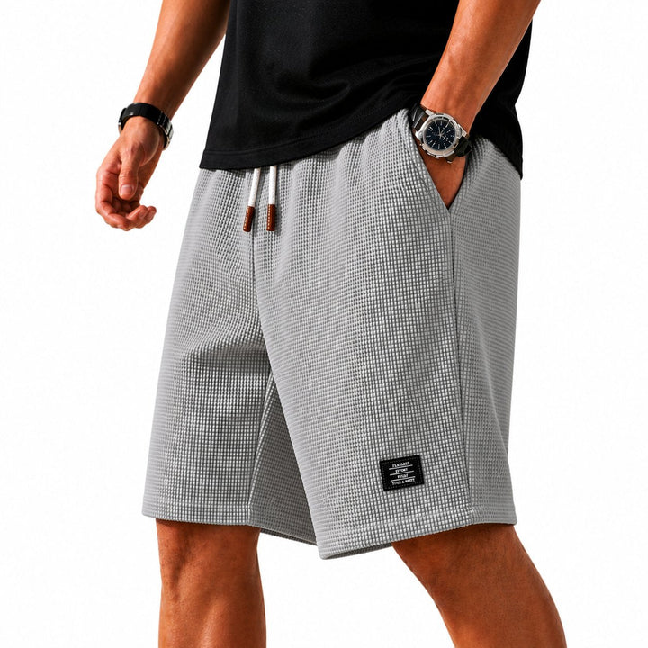 Men's athletic drawstring shorts with elastic waist, designed for summer comfort & outdoor adventures.