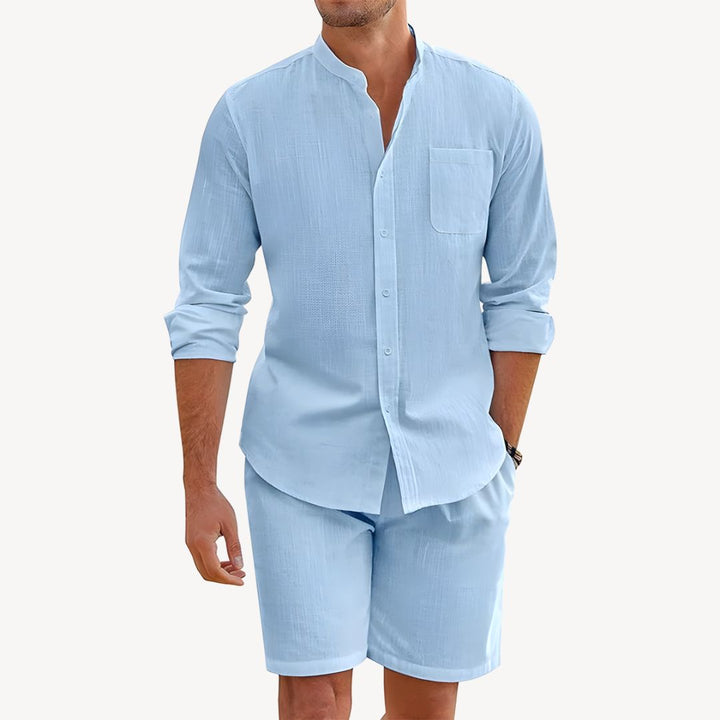 Stylish men's summer vacation outfit: lightweight button-up shirt & drawstring shorts co-ord set for casual wear.