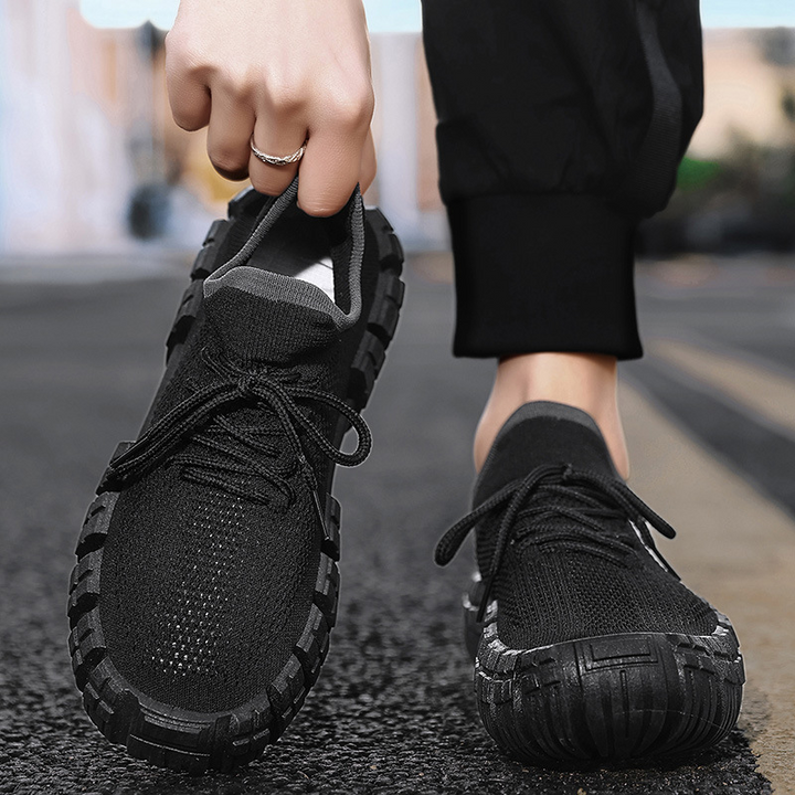 Close-up of breathable mesh material on men's lightweight urban agility sneakers, showing texture.