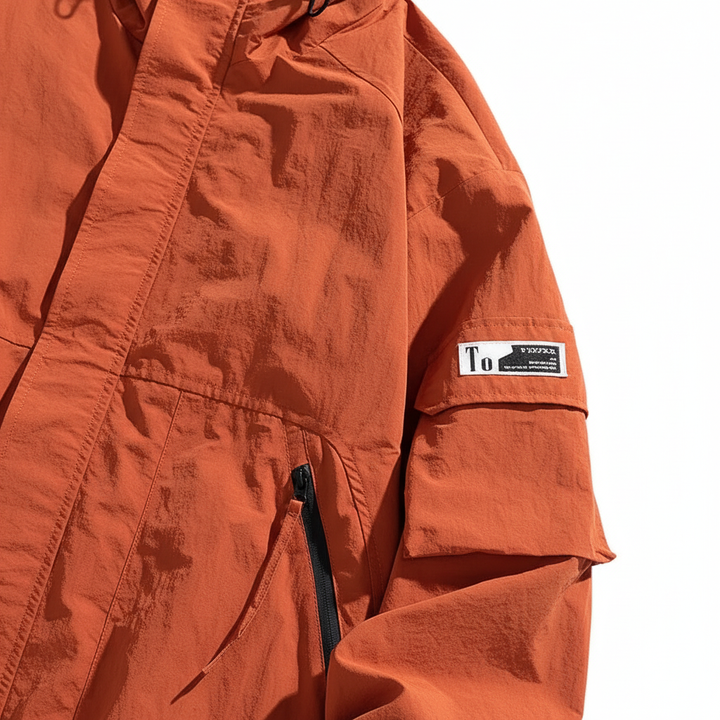 Fashionable man wearing a blue lightweight windbreaker jacket, suitable for autumn and active wear.