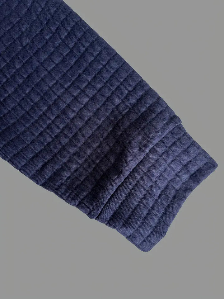 Stylish long sleeve polo for men, featuring a button placket, textured fabric, and sleeve pocket.
