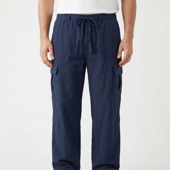 Relaxed fit men's cargo pants with utility pockets & drawstring waist for ultimate comfort & function.