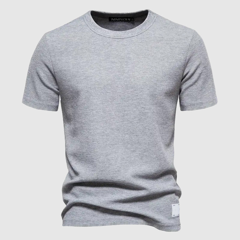 Close-up of the Men's Lorenzo Breeze Tee fabric, showcasing its breathable and soft texture for all-day comfort.