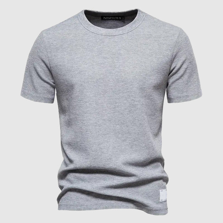 Close-up of the Men's Lorenzo Breeze Tee fabric, showcasing its breathable and soft texture for all-day comfort.