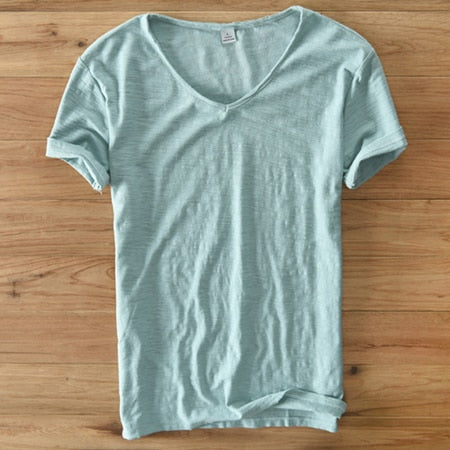 Detailed view of the short sleeve cuff on the men's white linen blend V-neck shirt