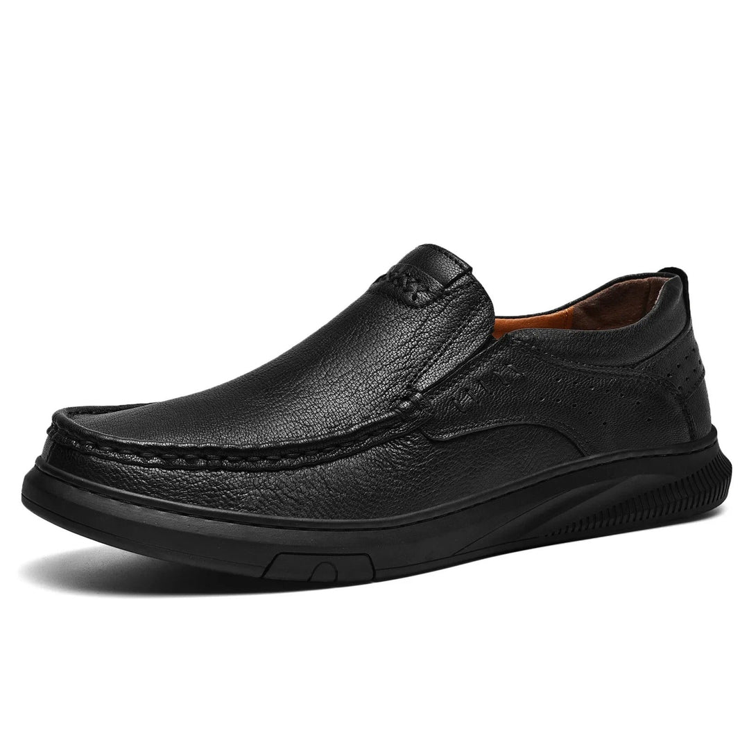 Sleek Men's Madison leather slip-on loafers in black, perfect easy wear for modern men's formal or casual fashion.