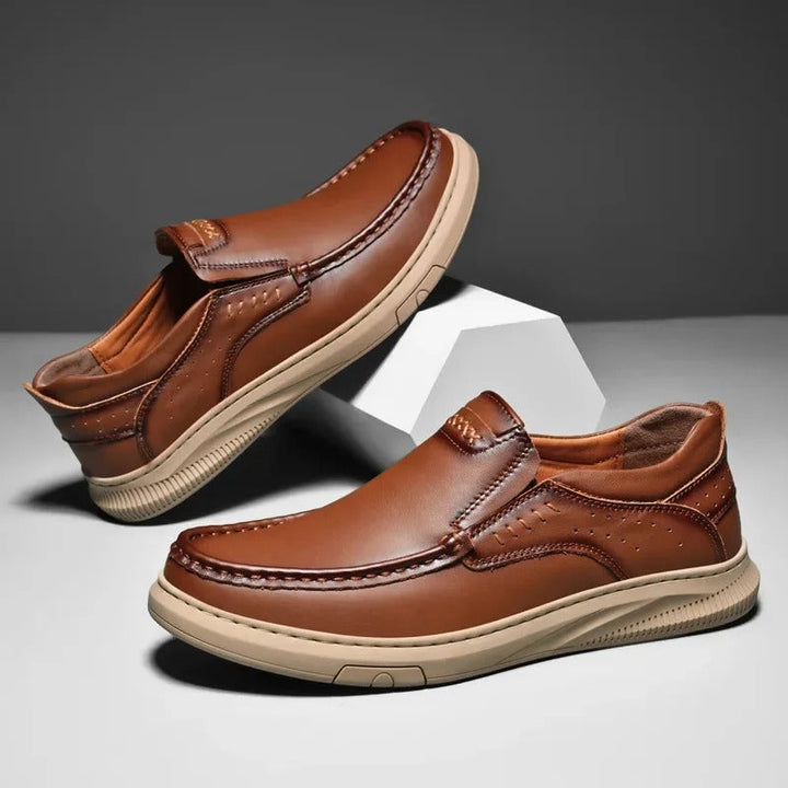 Brown leather Madison men's slip-on loafers, classic dress shoes for sophisticated office or casual wear.
