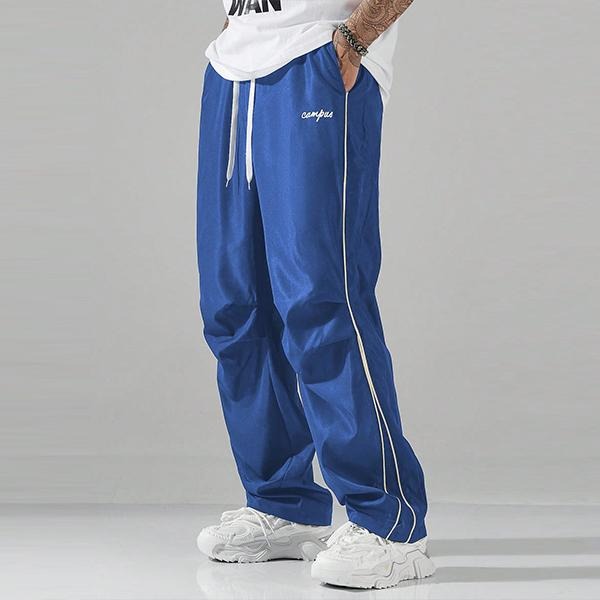 Stylish men's Matera track pants with a relaxed fit & drawstring, blending modern aesthetics for athletic or casual wear.