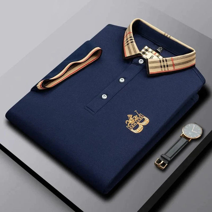 Close-up of embroidered detail on a men's short-sleeve Matthew polo shirt, highlighting quality.