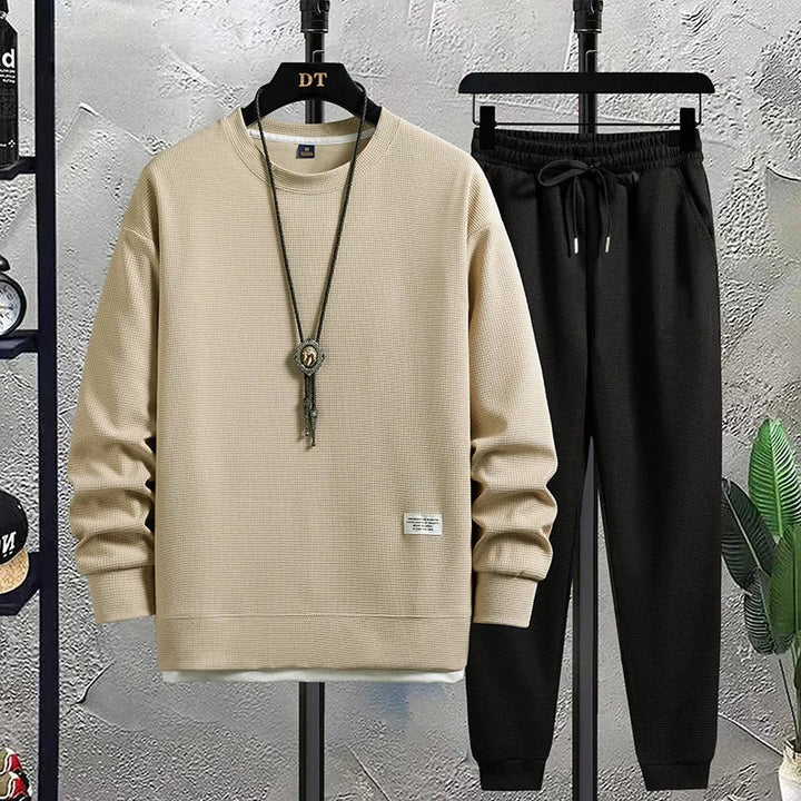 Stylish men's relaxed fit tracksuit. Two-piece set with comfy sweater & joggers for modern casual menswear.