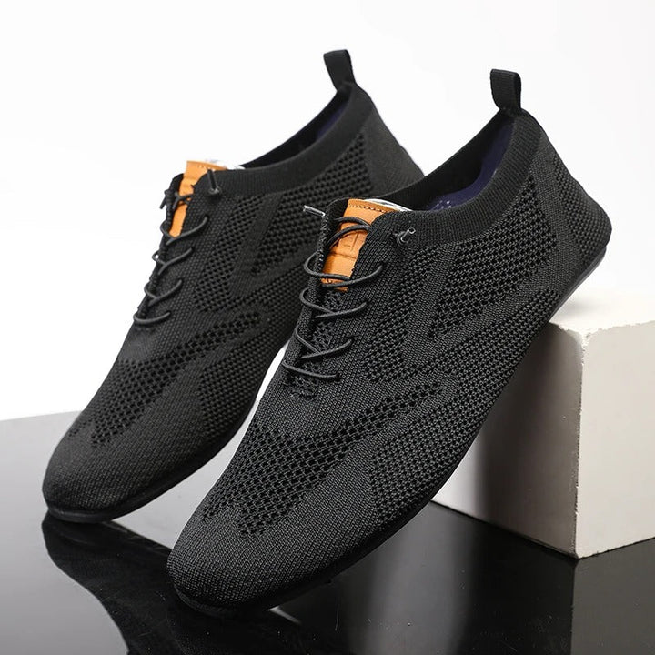 Breathable mesh knit men's slip-on sneakers, perfect for casual everyday comfort and lightness.