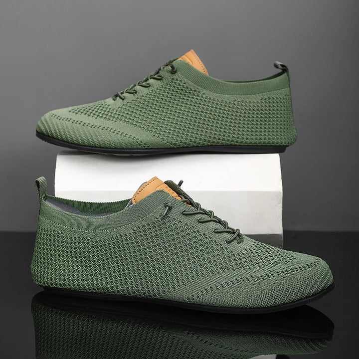 Modern men's knit slip-on sneakers, sleek design with breathable mesh for lightweight comfort.
