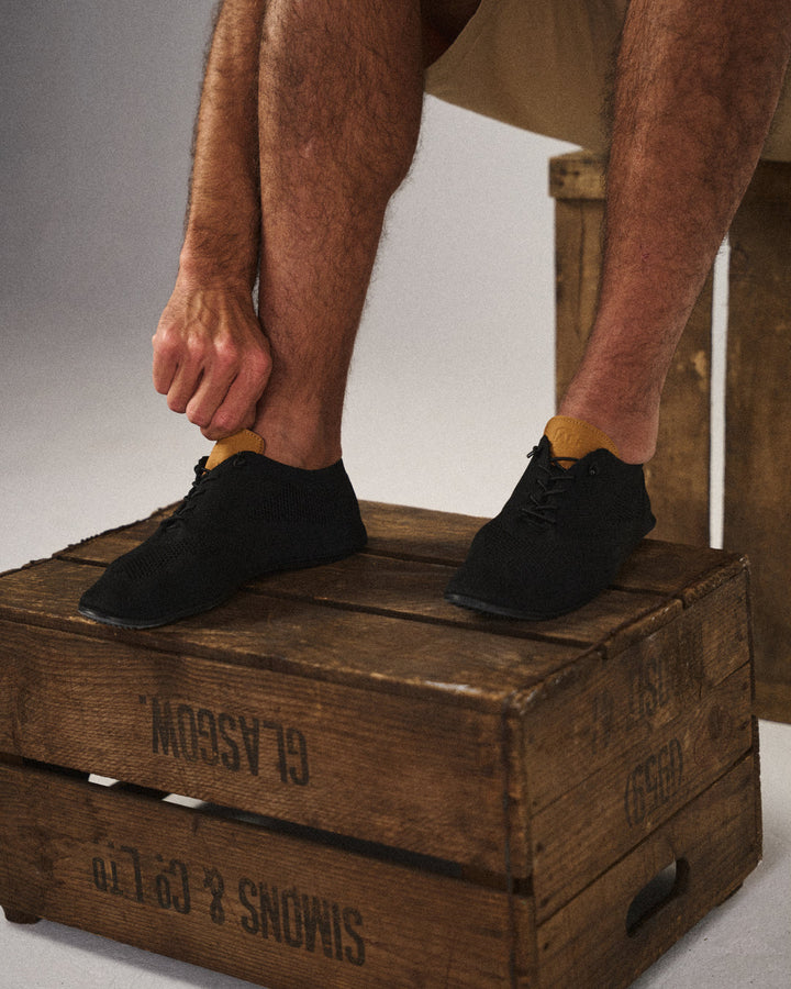 Side view of men's lightweight mesh knit slip-on sneaker, comfort sole for walking.
