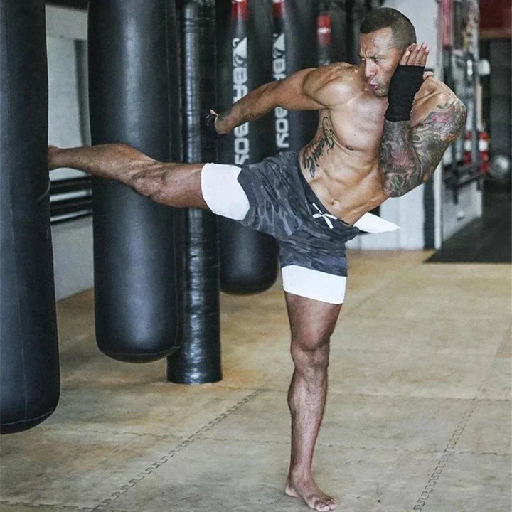 Active man in black dual layer running shorts, performing a stretch, summer workout
