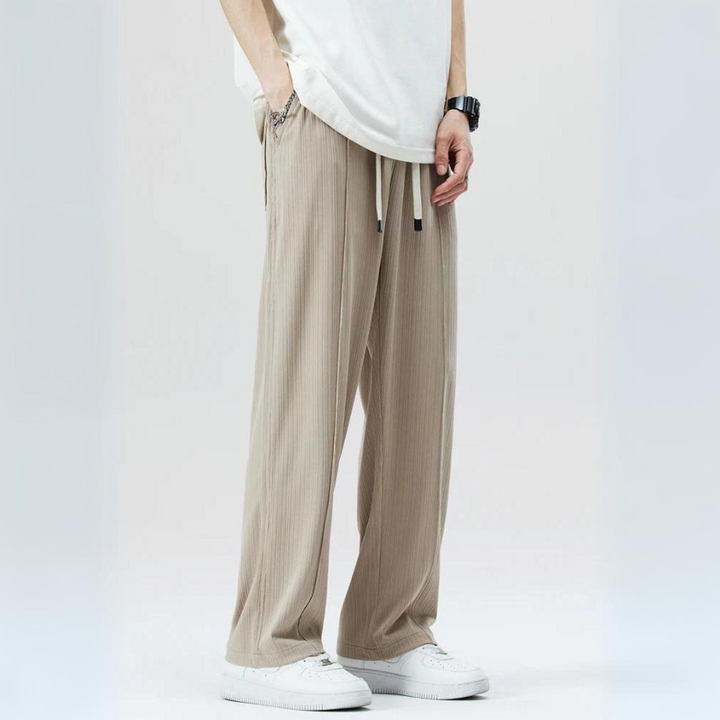 Black Milano pleated trousers for men. Smart casual comfort with an elastic waist & classic pleats.