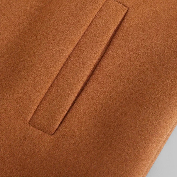 Man wearing a smart casual minimalist button winter coat, perfect for elegant autumn fashion.