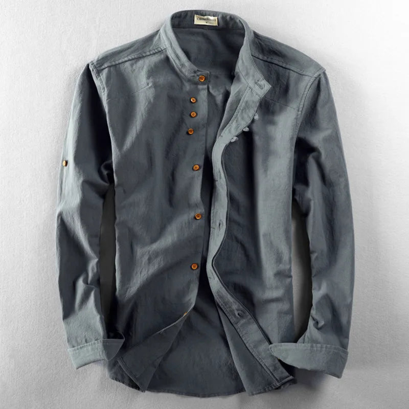Neatly folded white men's minimalist short sleeve band collar shirt, ideal for modern casual wear.