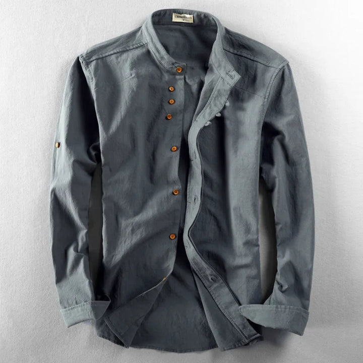 Neatly folded white men's minimalist short sleeve band collar shirt, ideal for modern casual wear.