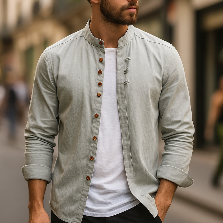 Man casually wearing a light gray minimalist band collar shirt. Modern short sleeve button-up for summer.