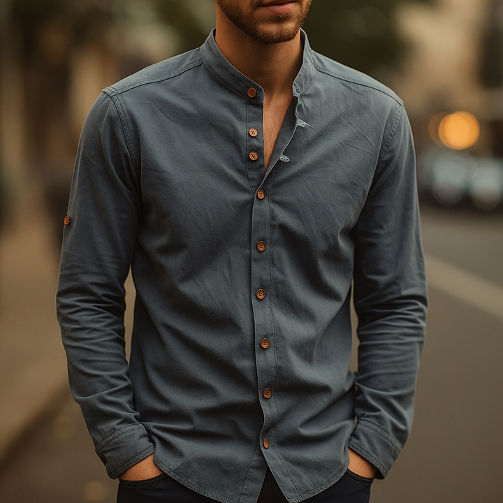 Textured fabric detail of a navy blue men's short sleeve band collar shirt. Minimalist and comfortable.