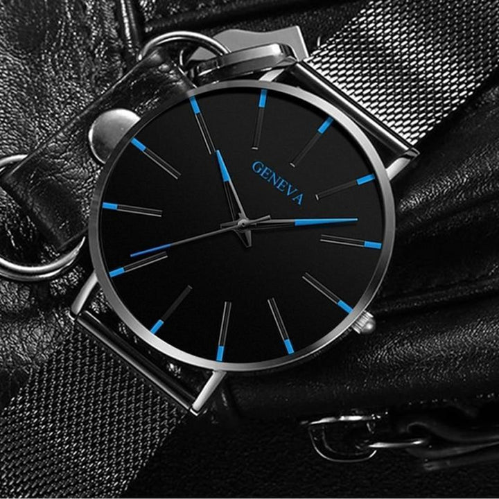 Elegant men's watch, minimalist design showcasing a clean face & striking blue accent on the minute hand.