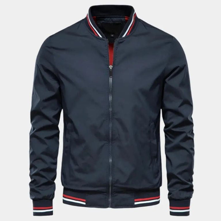 Stylish man in lightweight black bomber jacket, ideal for spring & fall fashion. Comfortable men's everyday wear.