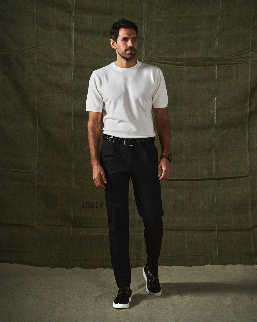 Detailed view of men's modern black slip-on loafers, showcasing texture and refined design.