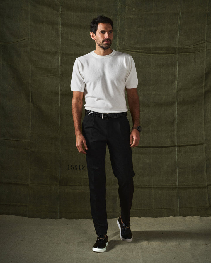 Detailed view of men's modern black slip-on loafers, showcasing texture and refined design.