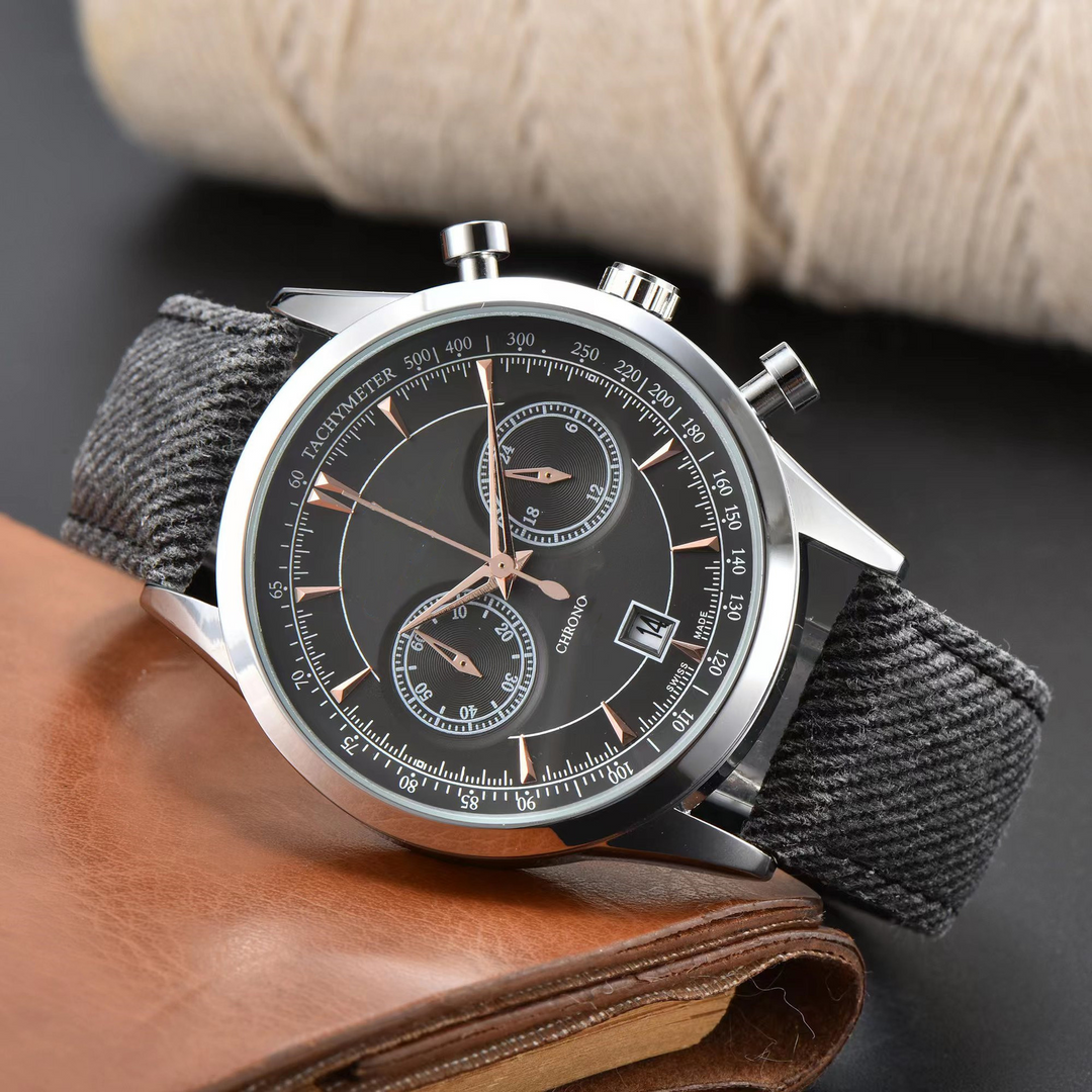 Men's modern chronograph watch with a grey canvas strap, stainless steel case, and black dial. Stylish and casual.
