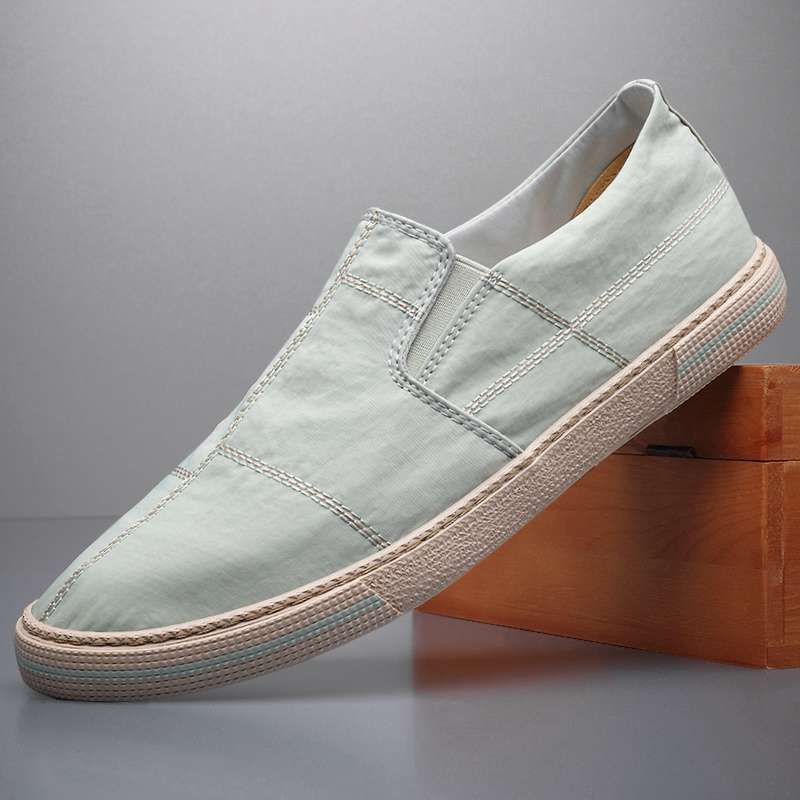 Stylish men's modern slip-on shoes, emphasizing comfort and breathability for active casual use.