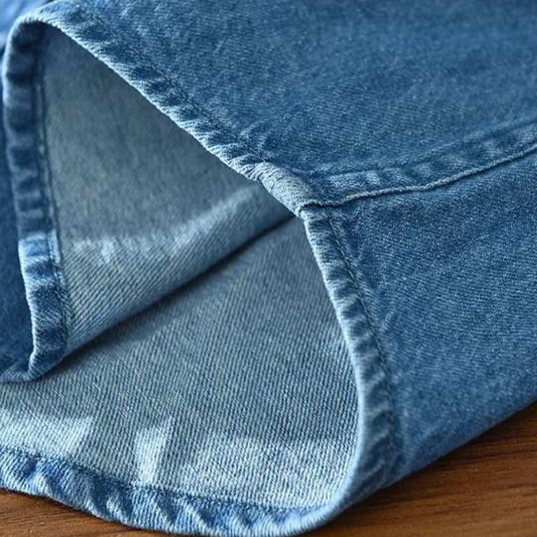 Folded men's blue denim shirt, a modern fit button-up, ready for everyday & casual wear.