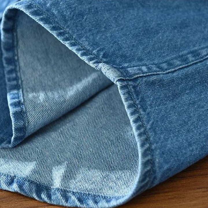Folded men's blue denim shirt, a modern fit button-up, ready for everyday & casual wear.