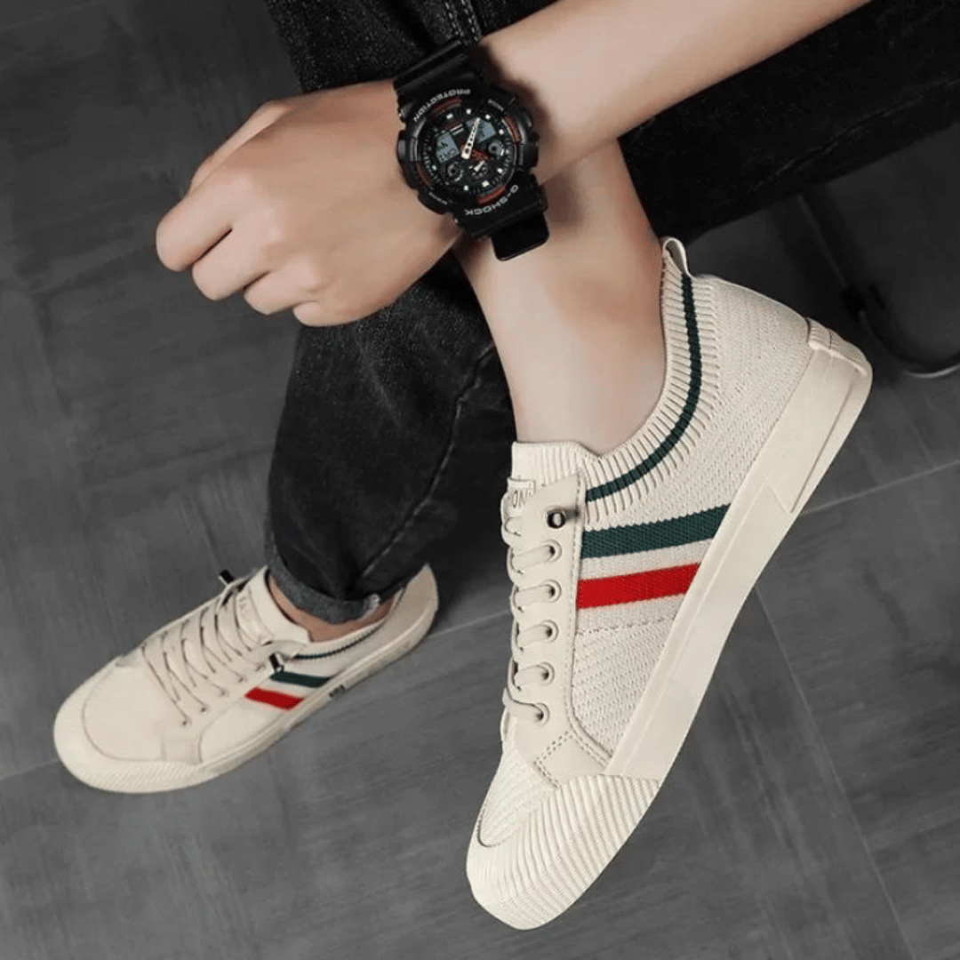 Close-up of men's athletic street runner sneakers, showcasing breathable upper material and modern design for comfort.