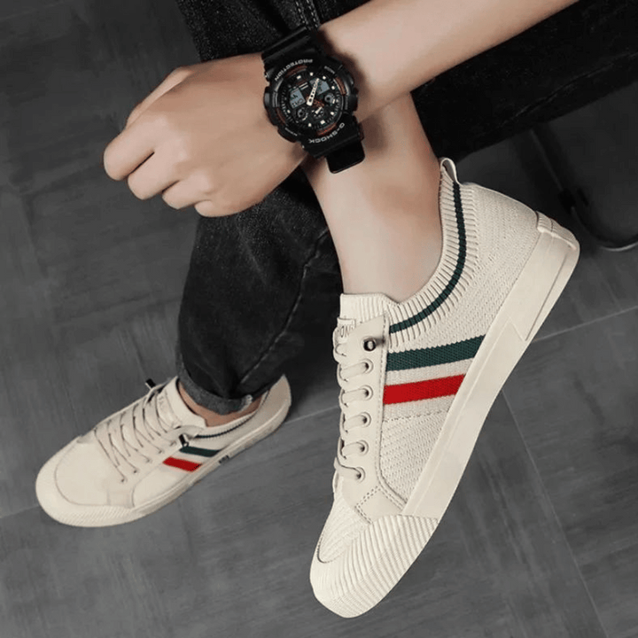 Close-up of men's athletic street runner sneakers, showcasing breathable upper material and modern design for comfort.