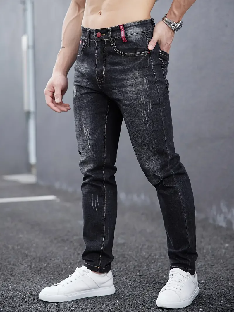 Distressed men's tapered jeans, a slim fit modern denim choice. Ideal for men's fashion & urban style.