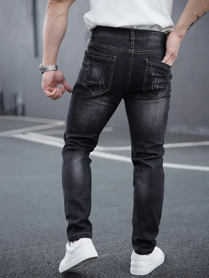 Modern tapered men's jeans, slim fit distressed stretch denim. Comfortable casual wear for men's fashion.