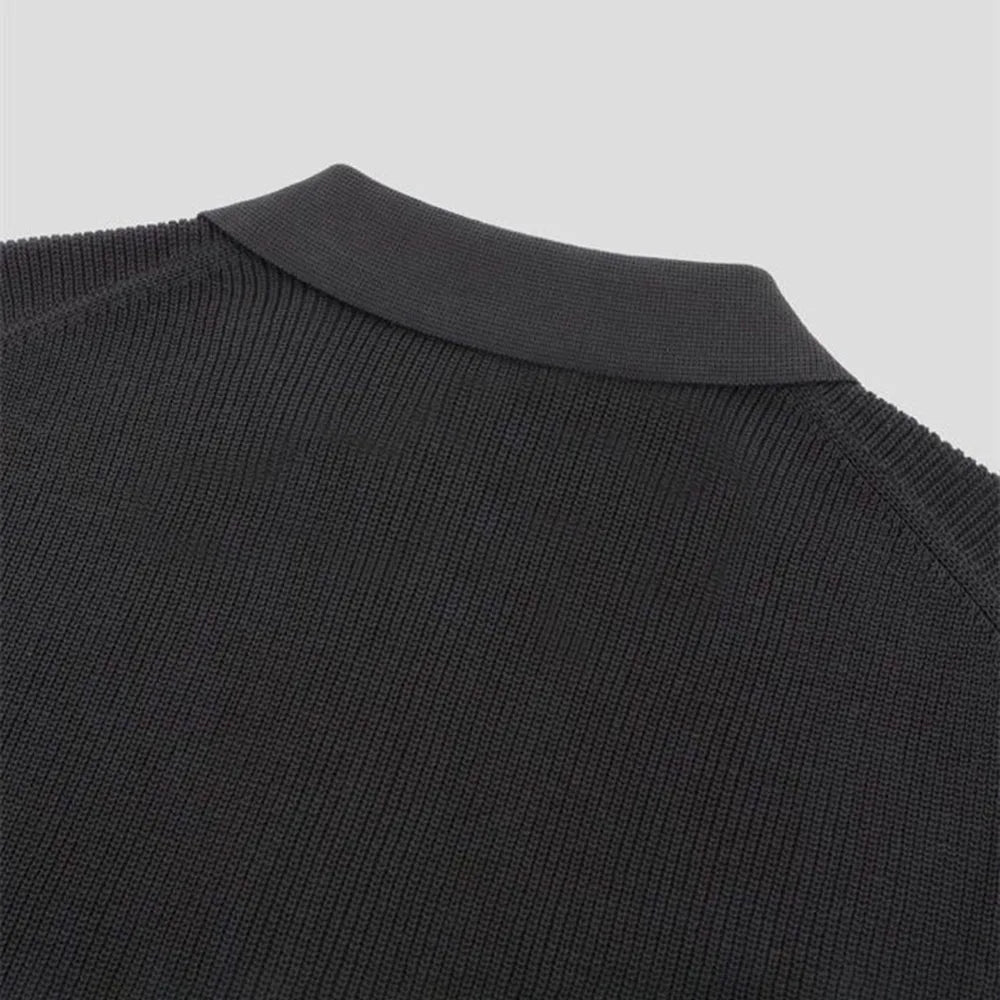Man wearing a dark men's tailored fit zip-up polo shirt, highlighting its comfortable and stylish appeal.
